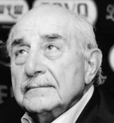 Black and white portrait of an elderly man with a mustache.